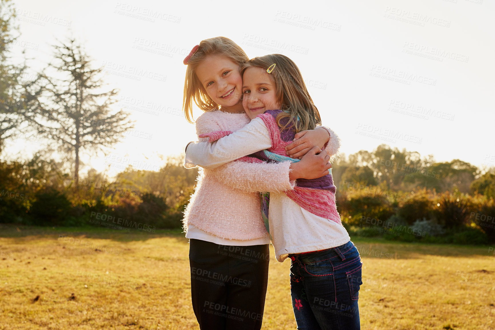 Buy stock photo Happy, young girls and hug for siblings outdoor at park or for bonding and fun on summer holiday. Excited, children and love embrace in portrait for friendship and quality time together on vacation