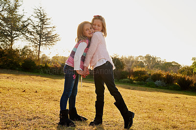 Buy stock photo Children, happy and portrait hug in park on for bonding, childhood and having fun on field. Kids, outdoors and girls embrace for playing together with love, adventure and freedom for friendship