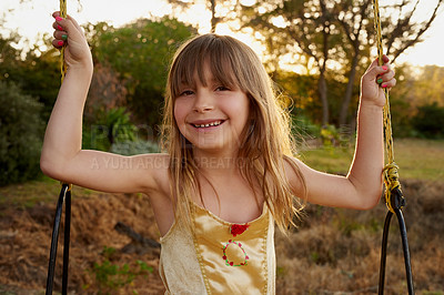 Buy stock photo Portrait of a little girl sitting on a swing outside