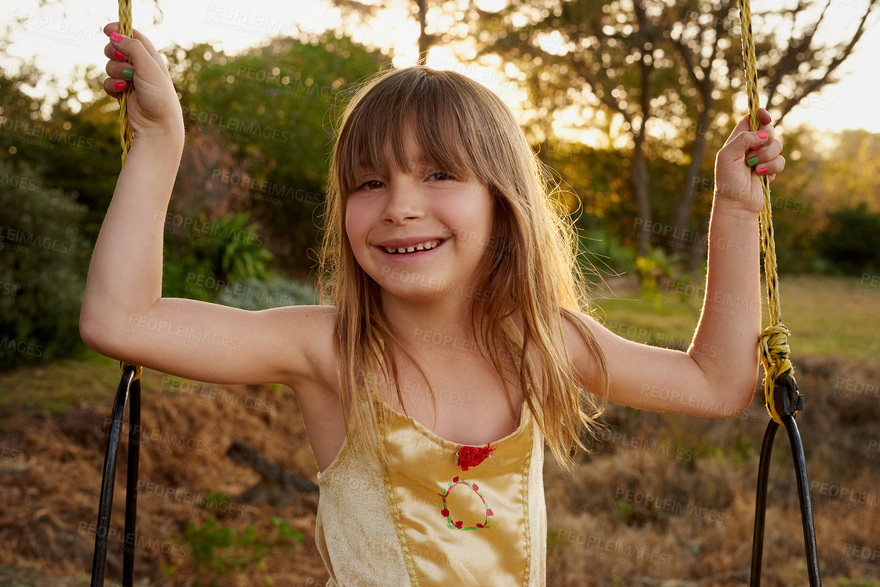 Buy stock photo Portrait of a little girl sitting on a swing outside