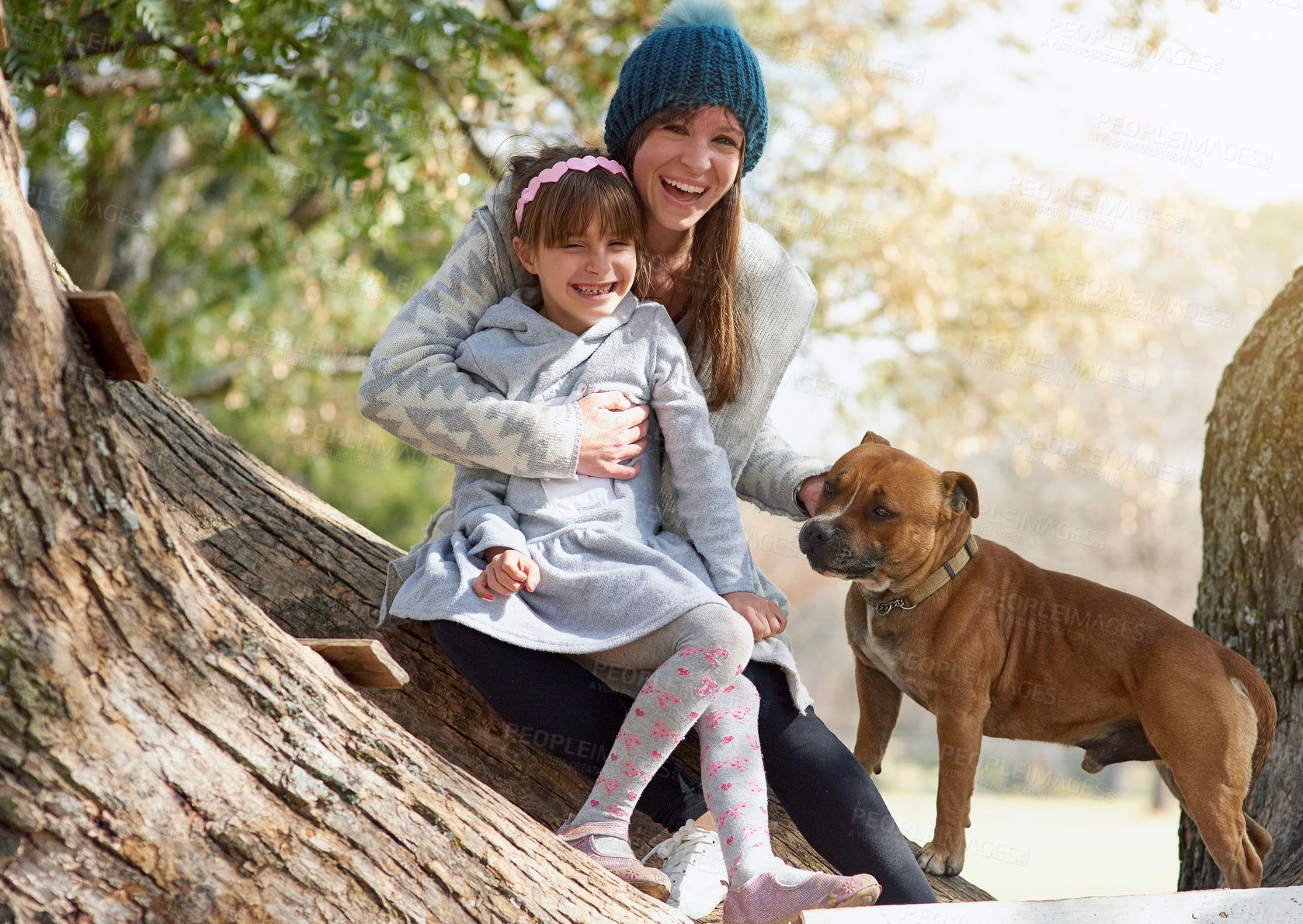 Buy stock photo Happy mother, child and dog with hug for bonding and quality time outside in nature on winter break. Family, woman and girl with pet for love embrace,  relax together and vacation with sunshine