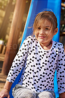 Buy stock photo Portrait, slide and playground for child in nature, park and garden for play and fun. Face, smile and outdoors and games for energy for childhood development, vacation and weekend break in summer  