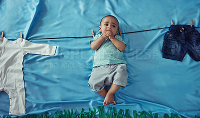 Buy stock photo Concept shot of an adorable baby boy hanging on a make believe clothes line
