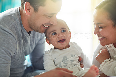 Buy stock photo Shot of an adorable baby boy bonding with his father and father at home