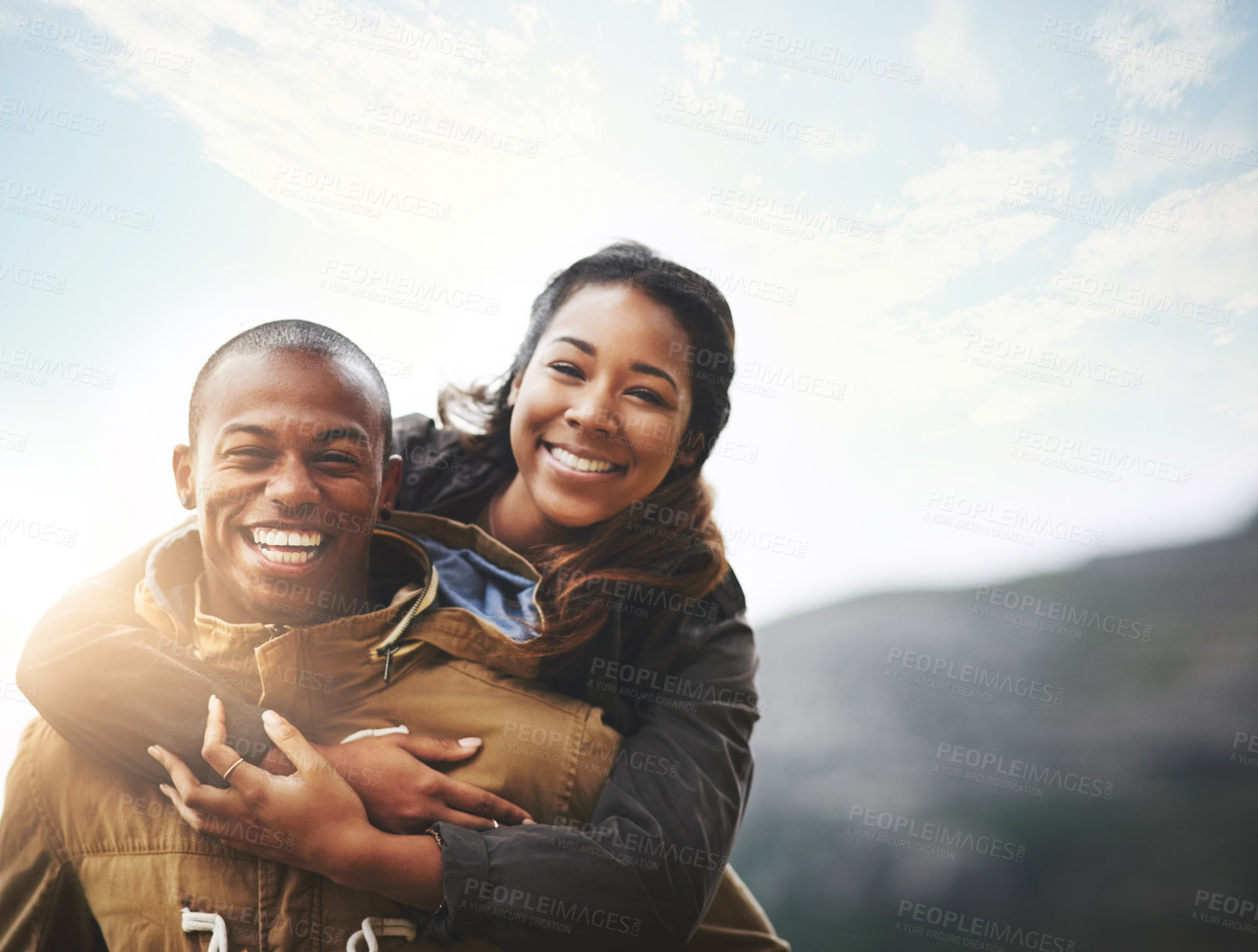 Buy stock photo Portrait of a happy young couple having fun outside