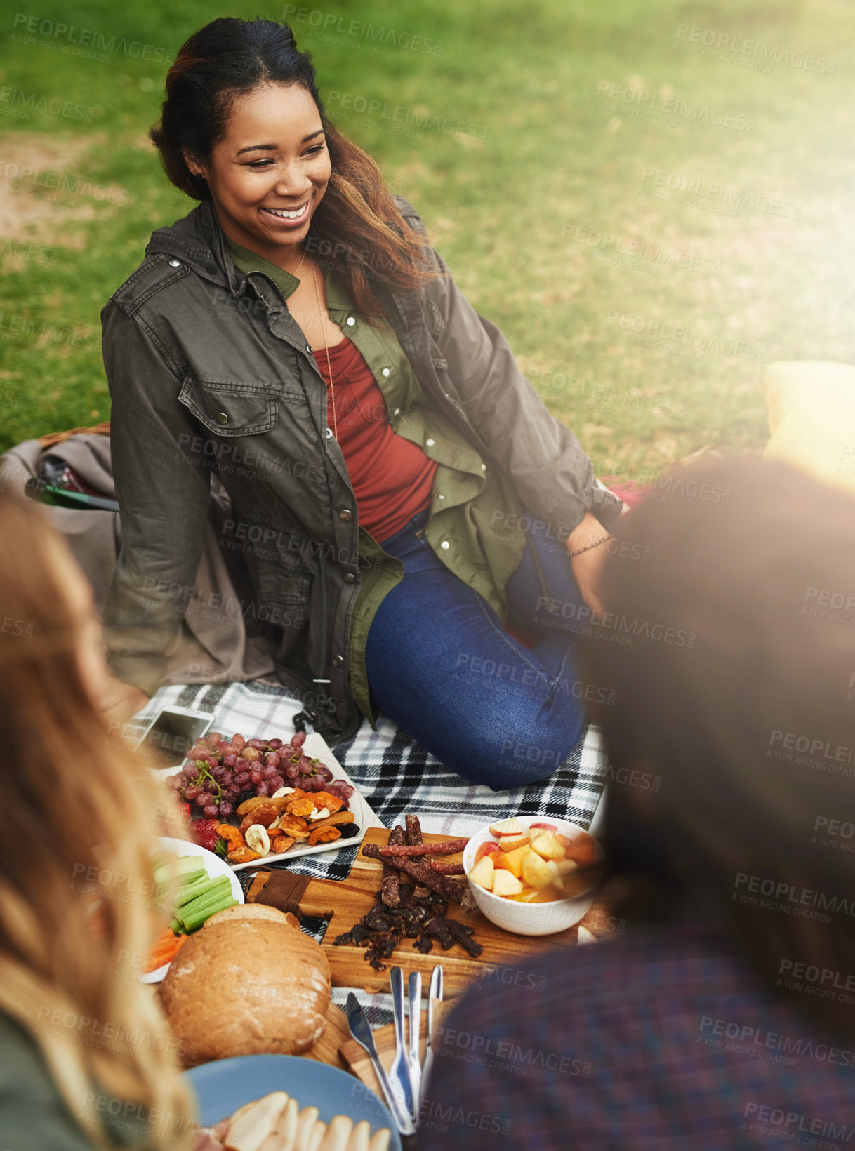 Buy stock photo Happy, picnic and woman with friends in park for bonding, social gathering and together outdoors. Smile, relax and men and women on grass in nature for holiday, vacation and adventure on weekend