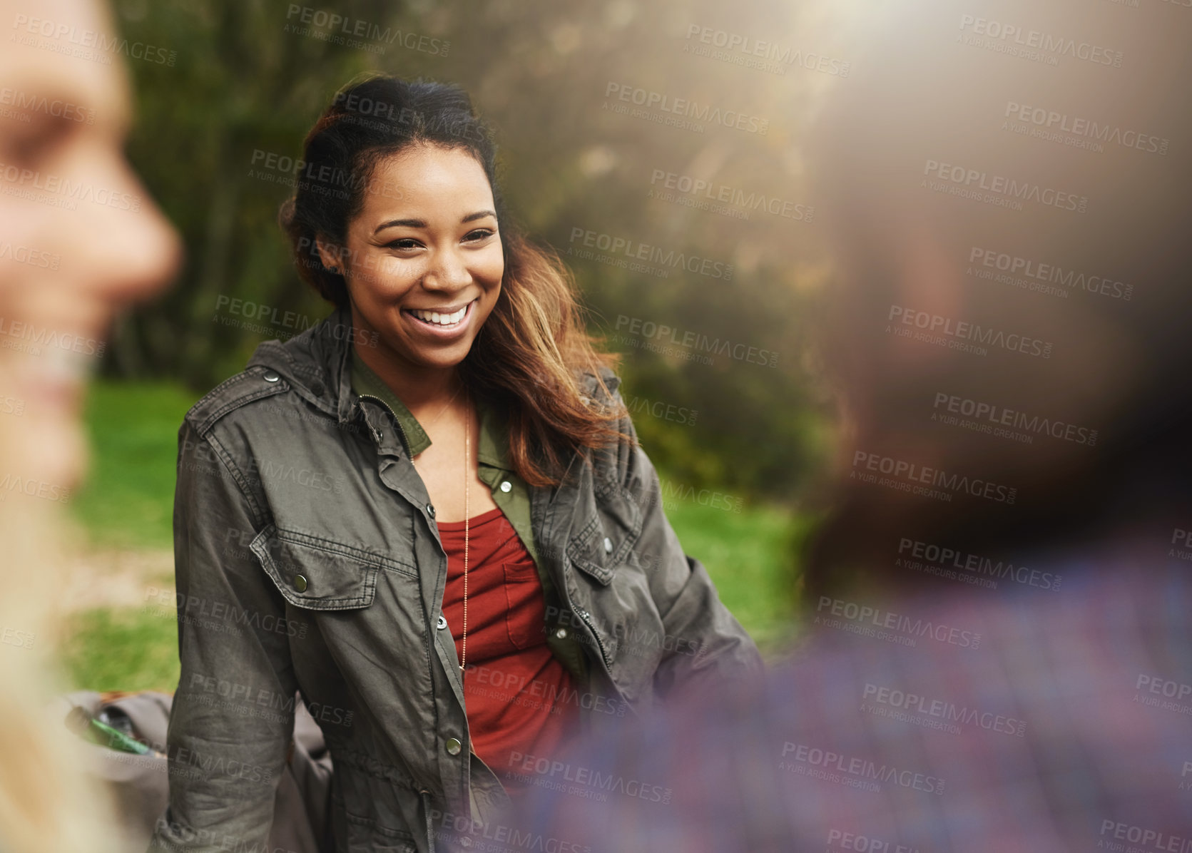 Buy stock photo Happy, laugh and woman with friends in park for bonding, social gathering and together outdoors. Smile, relax and men and women on grass in nature for holiday, vacation and adventure on weekend