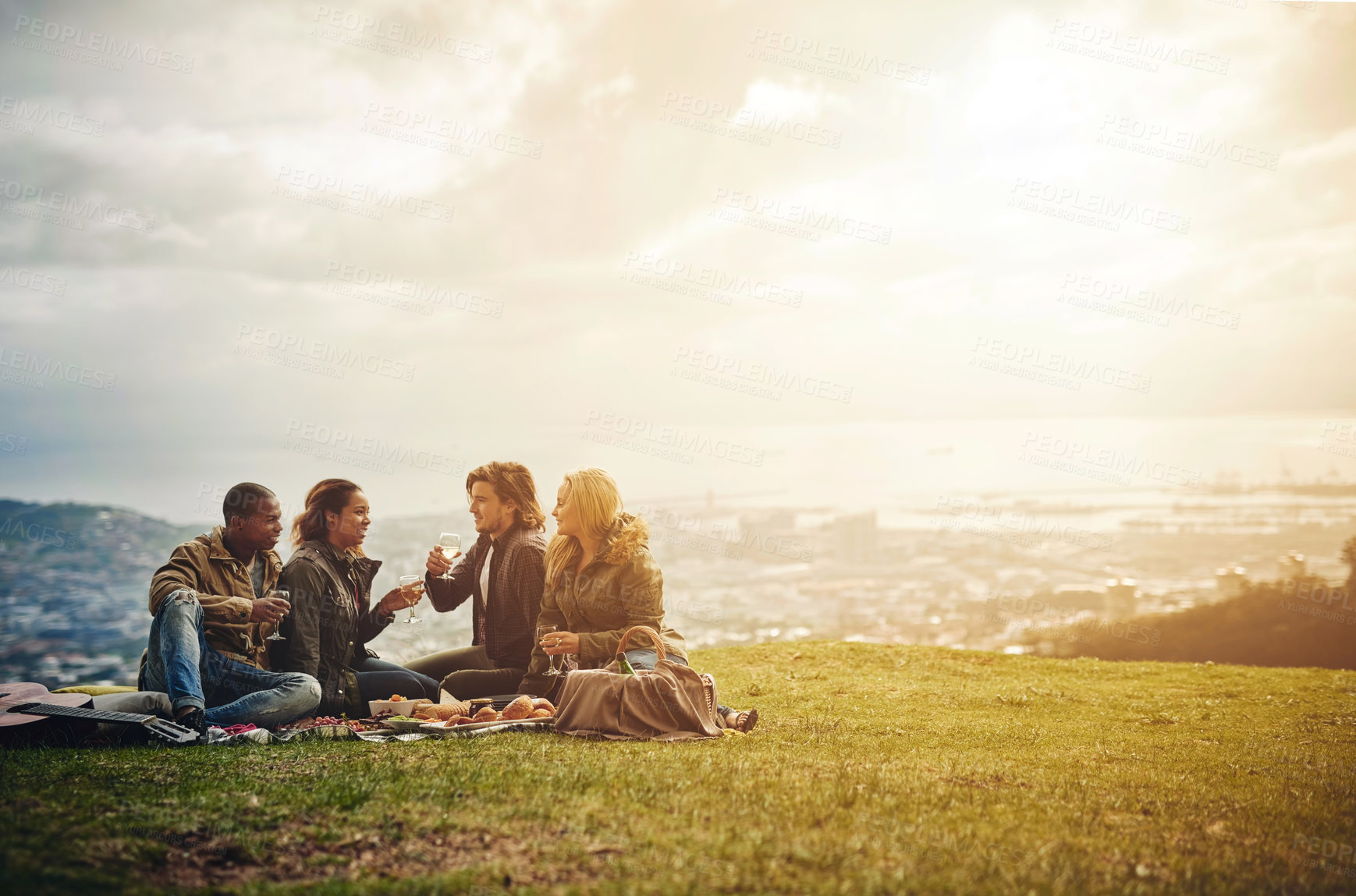 Buy stock photo Shot of a group of young friends having fun at a picnic