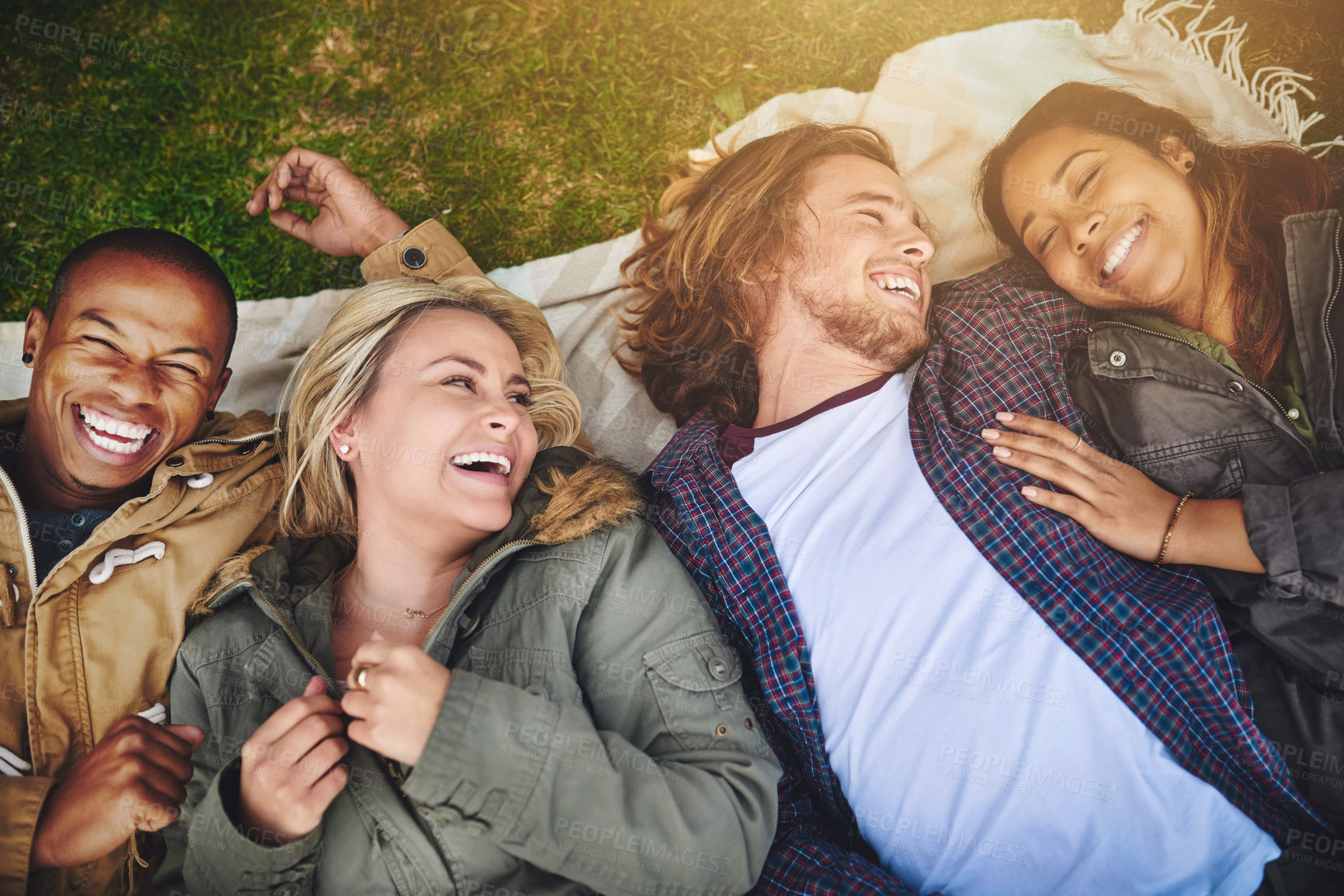 Buy stock photo Shot of a group of young friends having fun at a picnic