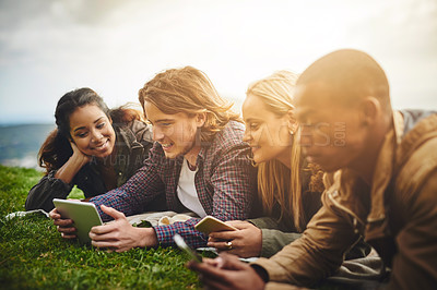 Buy stock photo Shot of a group of young friends having fun at a picnic
