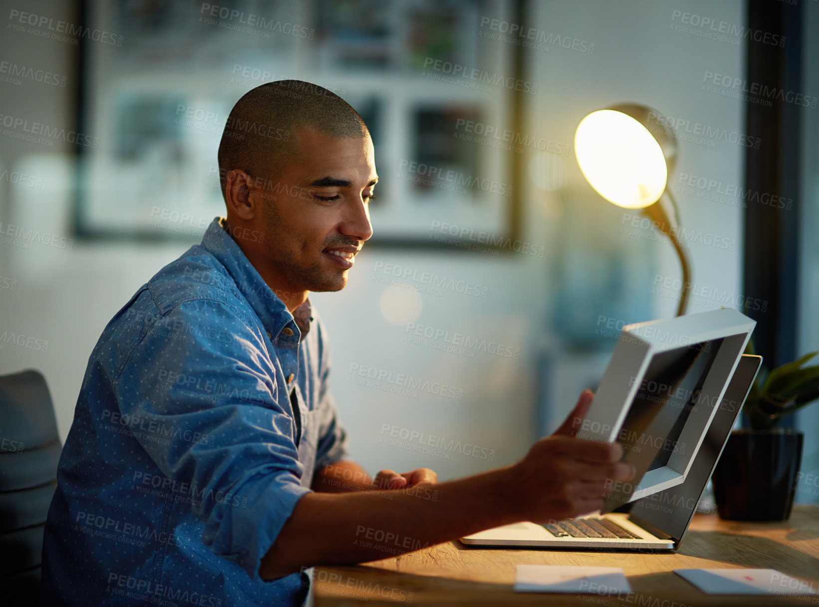 Buy stock photo Thinking, man or photo frame at desk with laptop for late work, good memories or nostalgia at night. Happy, male editor or holding picture for sentiment in office at computer, after hours or deadline