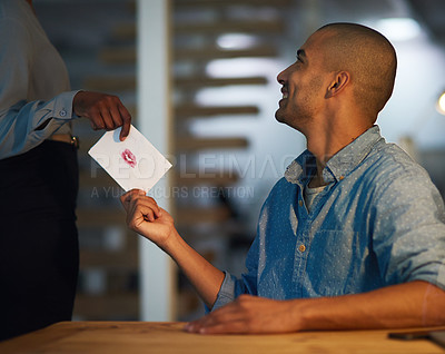 Buy stock photo Cropped shot of a young businessman receiving a love note from a secret admirer