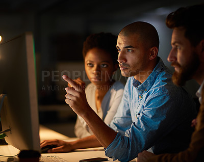 Buy stock photo Cropped shot of a group of colleagues working late in an office