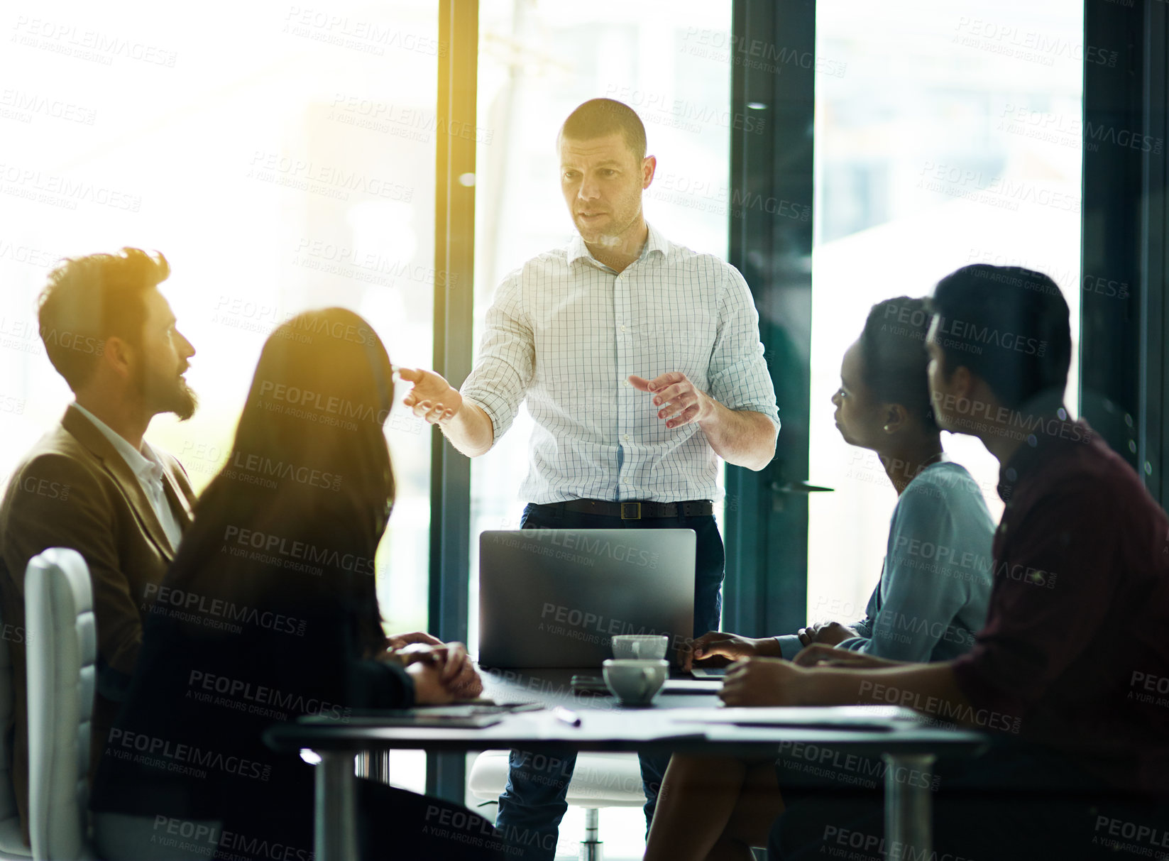 Buy stock photo Businessman, coach and presentation with laptop in meeting for collaboration, ideas or training staff at office. Man or employee talking to group of employees in brainstorming discussion at workplace