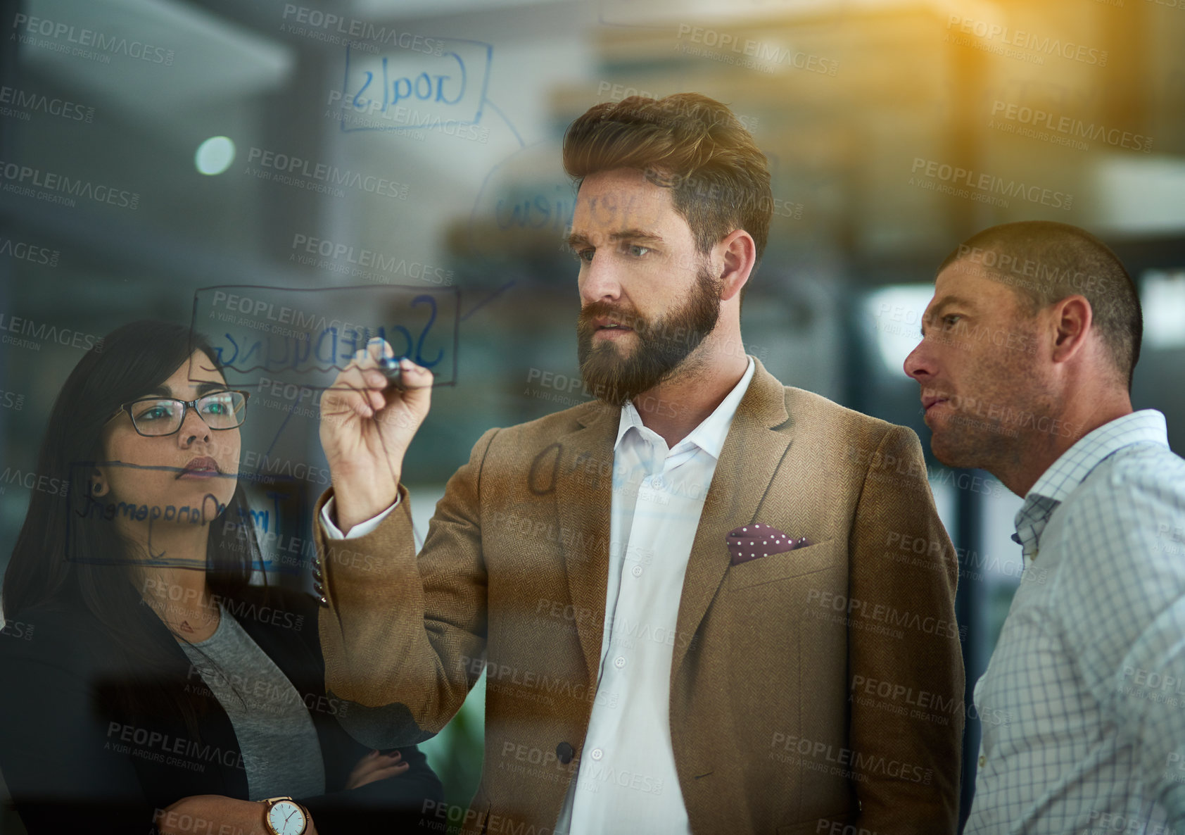 Buy stock photo Businessman, writing and schedule planning with glass board for tasks or brainstorming at office. Young man or employee with team on mind map for group project, agenda or productivity at workplace