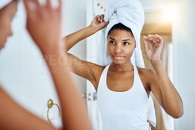 Buy stock photo Shot of an attractive young woman going through her morning beauty routine