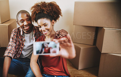 Buy stock photo Cropped shot of a young couple taking a selfie in their new home