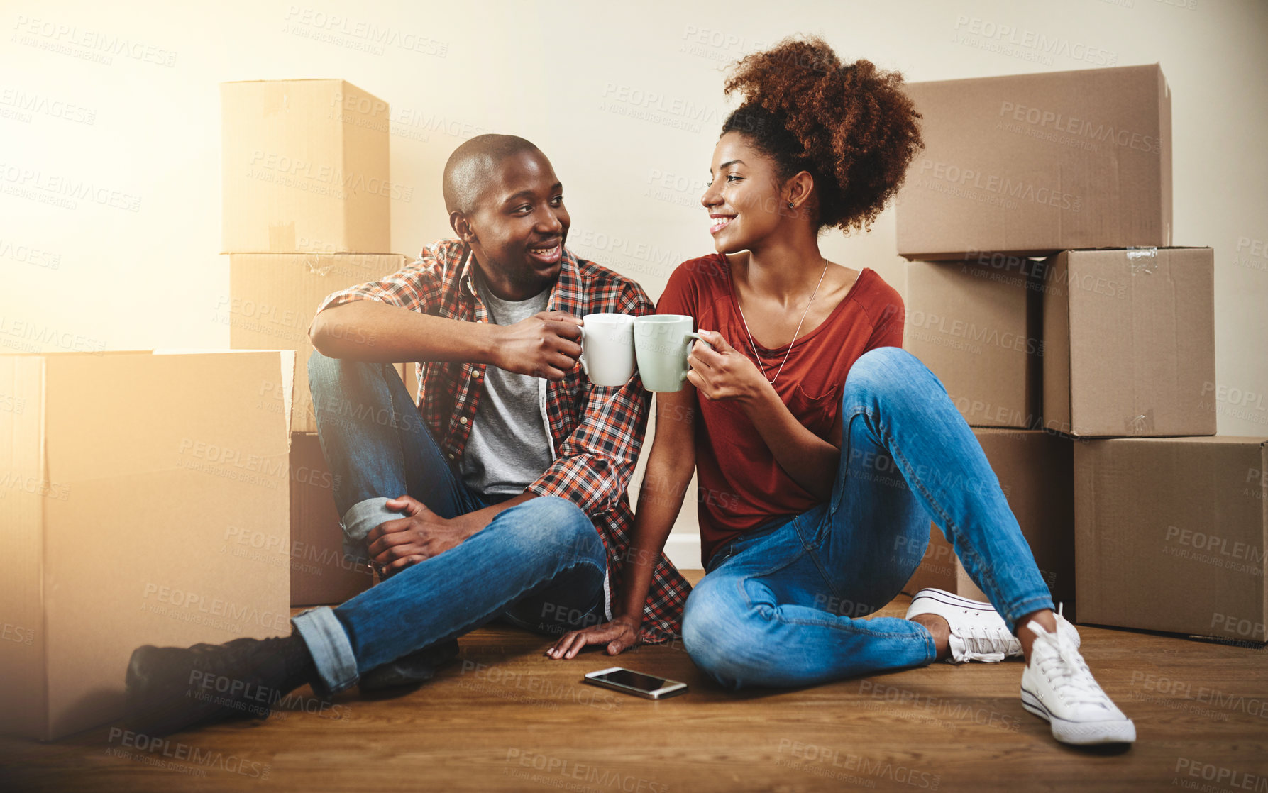 Buy stock photo Black couple, cheers and coffee on floor of new home with bonding, support and happy for break from moving. People, homeowner and toast for property investment, dream house and relocation with boxes