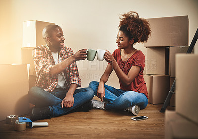 Buy stock photo Black couple, cheers and cup on floor of new house with bonding, support and happy for coffee break from moving. People, success and toast for property investment, dream home or relocation with boxes