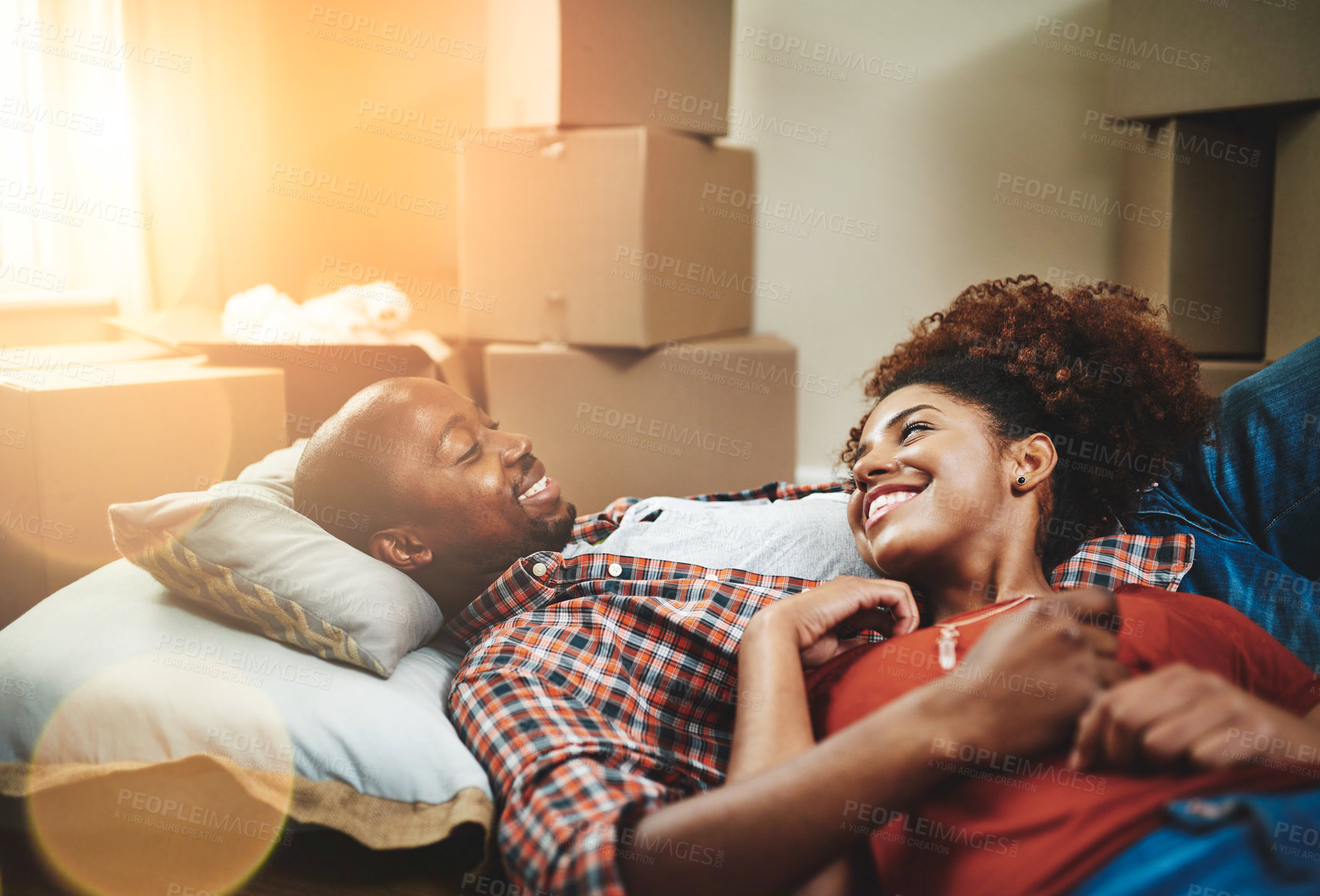 Buy stock photo Black couple, relax and happy on floor of new house with bonding, support and break from moving. People, homeowner and excited for property investment, dream home or real estate relocation with boxes