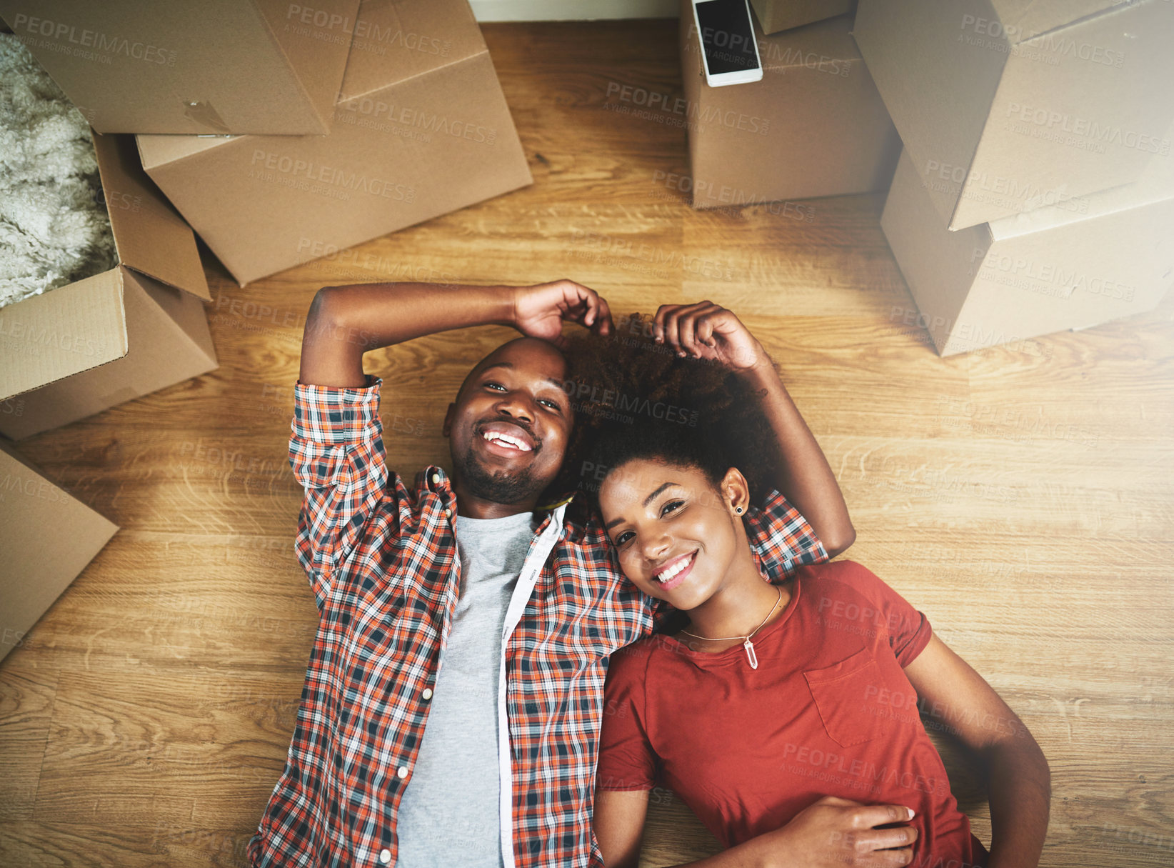 Buy stock photo Black couple, portrait or happy on floor of new house with bonding, support or break from moving with top view. People, homeowner or smile for property investment, dream home or relocation with boxes