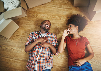 Buy stock photo Relax, laughing and couple on floor in new home with boxes, fun talking and mortgage with top view. Smile, black man and woman in house together with happy discussion, love and property investment