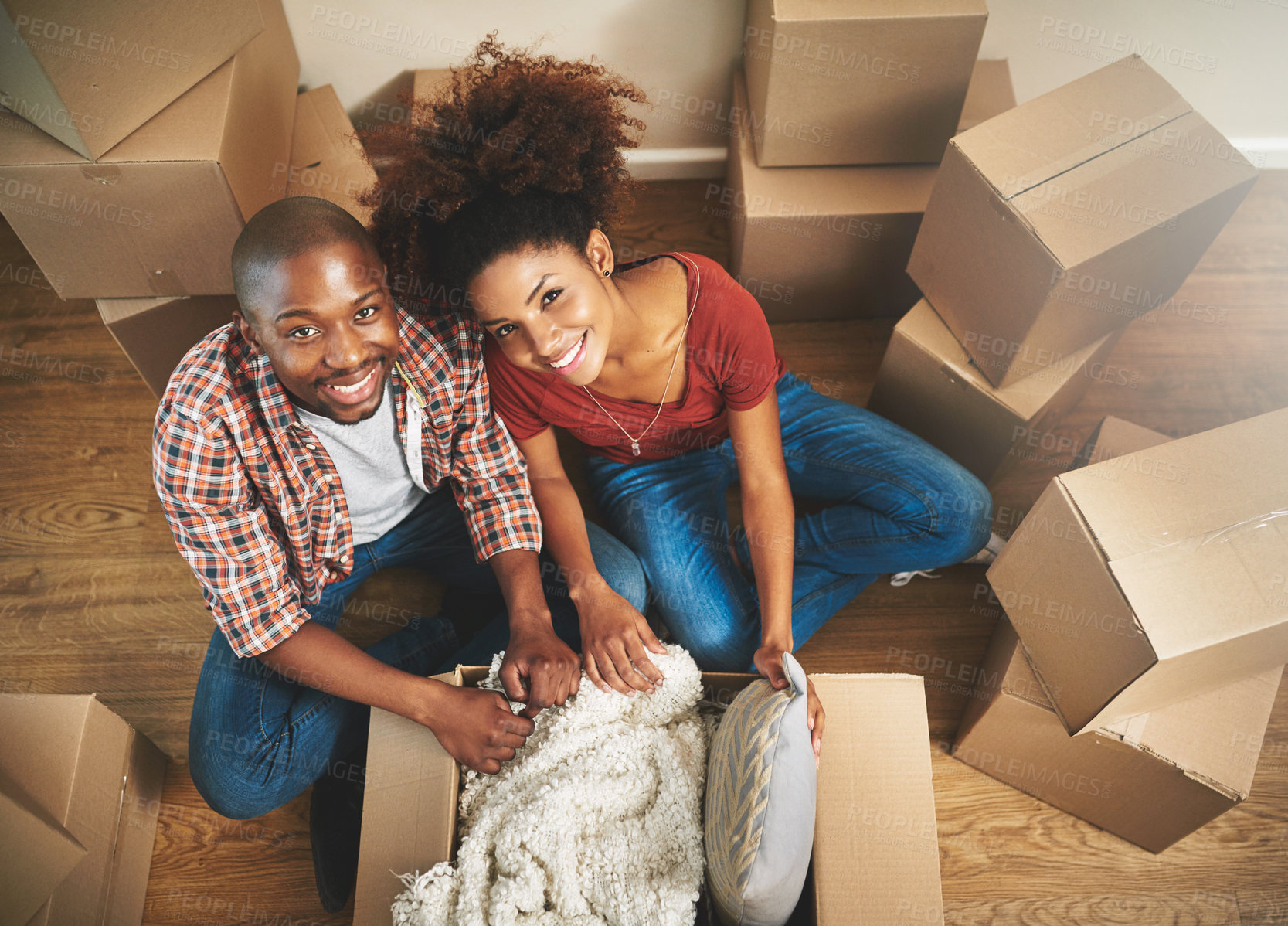 Buy stock photo Portrait, boxes and black couple on floor in new home with moving, smile and mortgage with top view. Relax, man and happy woman in apartment together with packing, love and property investment.