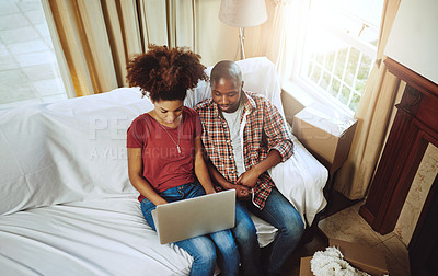 Buy stock photo Cropped shot of a young couple using a laptop while moving into their new home