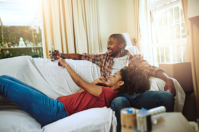 Buy stock photo Cropped shot of a young couple relaxing together at home