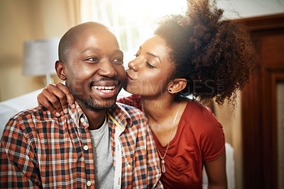 Buy stock photo Kiss, love and black couple on sofa in home with affection, marriage and carefree in living room. Smile, happy man and woman on couch with romantic embrace, gratitude and excited together in house.