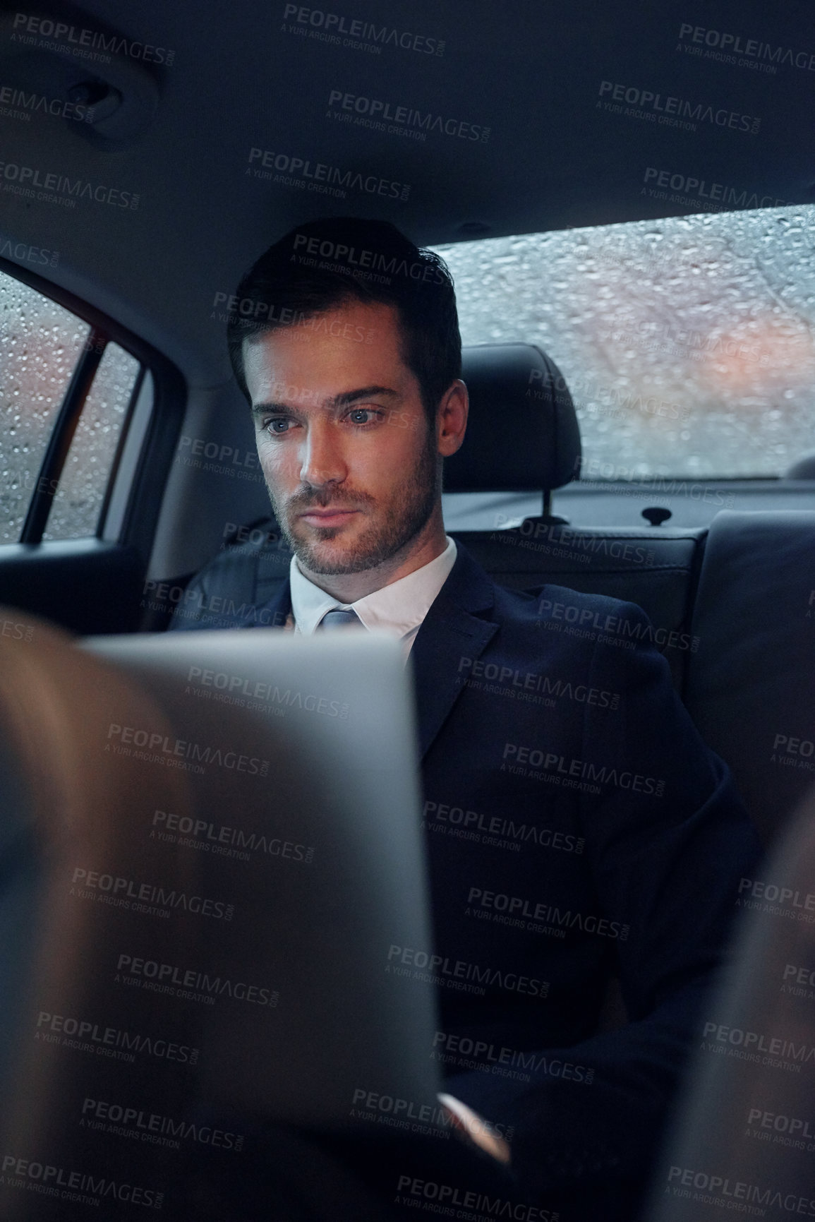 Buy stock photo Businessman, car and laptop for transportation travel to work meeting or airport, raining or commute. Male person, backseat and entrepreneur for tech company or city chauffeur for trip, cab or taxi