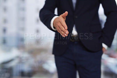 Buy stock photo Cropped shot of a businessman standing outside extending a handshake
