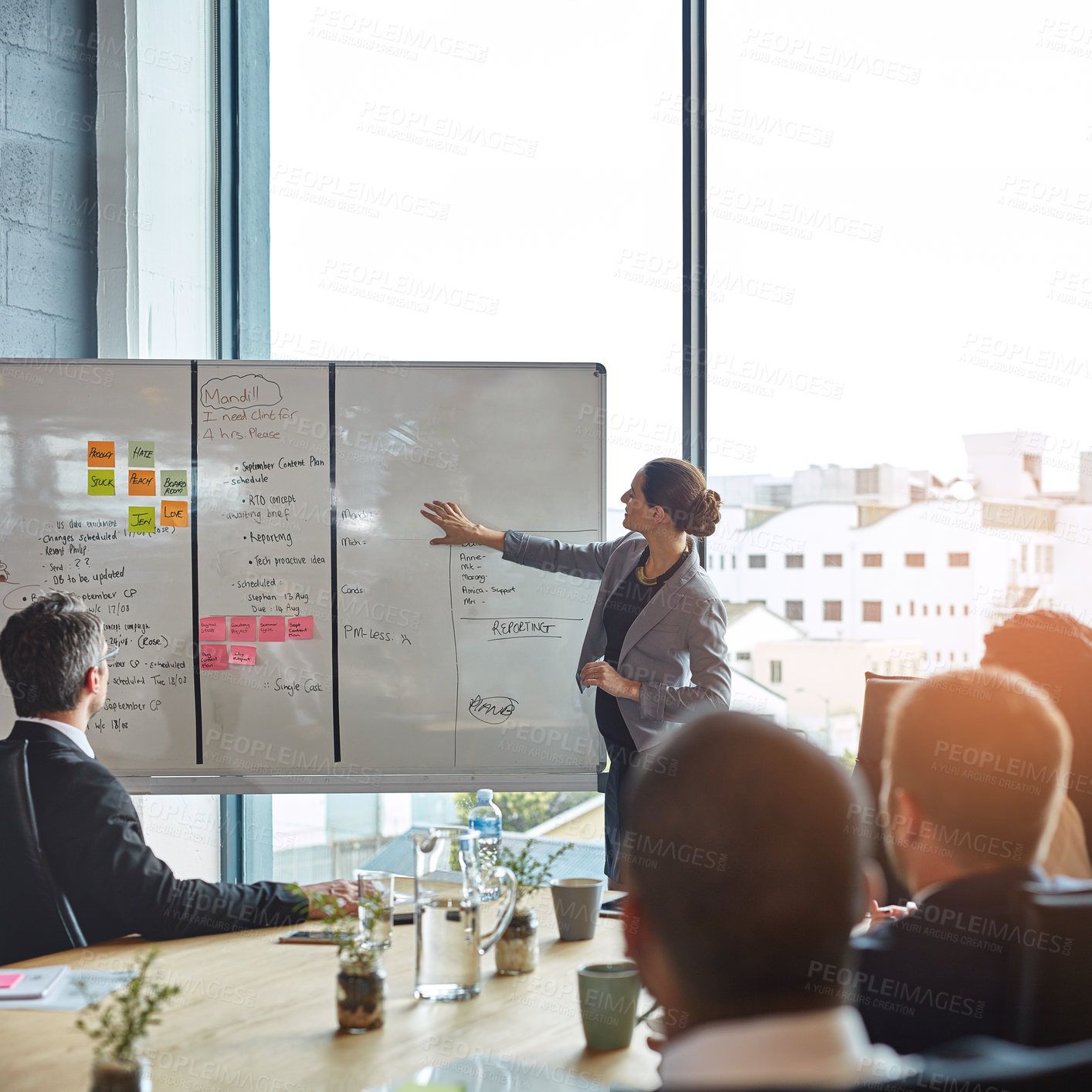 Buy stock photo Business people, whiteboard and woman speaker with presentation in office for planning, schedule or project management. Leadership, coaching and manager hand pointing to objectives, note or priority