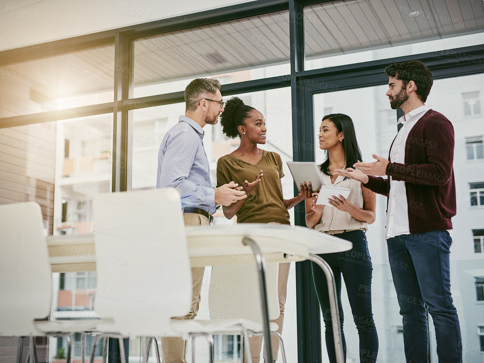 Buy stock photo Shot of a group of colleagues having a meeting in a modern office