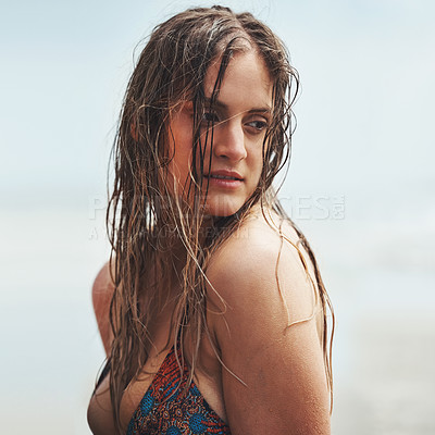 Buy stock photo Shot of an attractive young woman standing on a beach