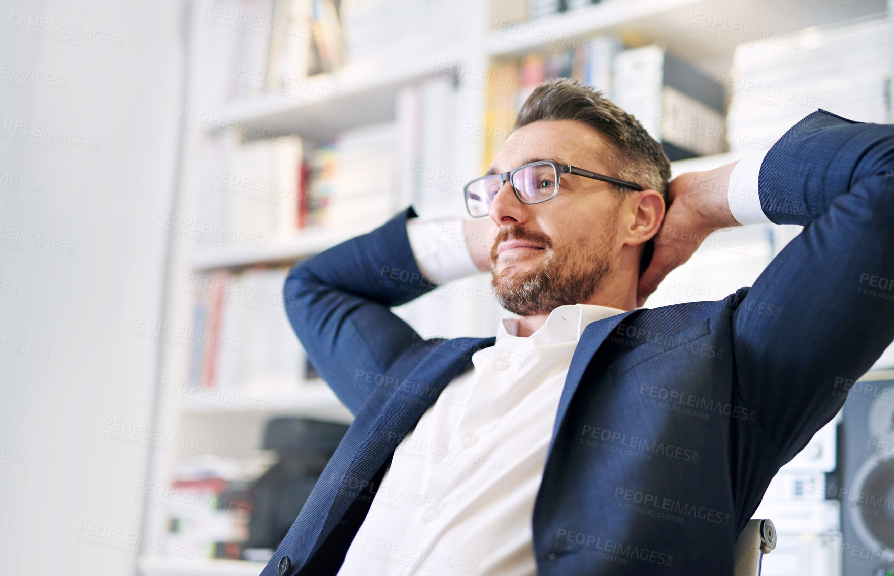 Buy stock photo Businessman, relax and corporate office, smile and happy male person with bookshelf and books for information. Proud, finish tasks and calm for goals done and targets reach in professional workplace