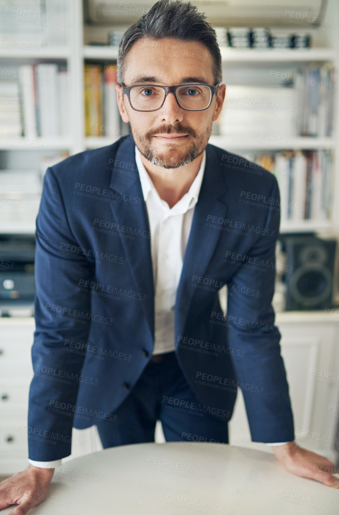 Buy stock photo Portrait, serious and business man on desk in office for career or job in Ireland at workplace. Glasses, worker or professional salesman on table, entrepreneur or confident corporate employee in suit