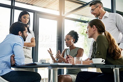 Buy stock photo Shot of a group of colleagues working together in an office