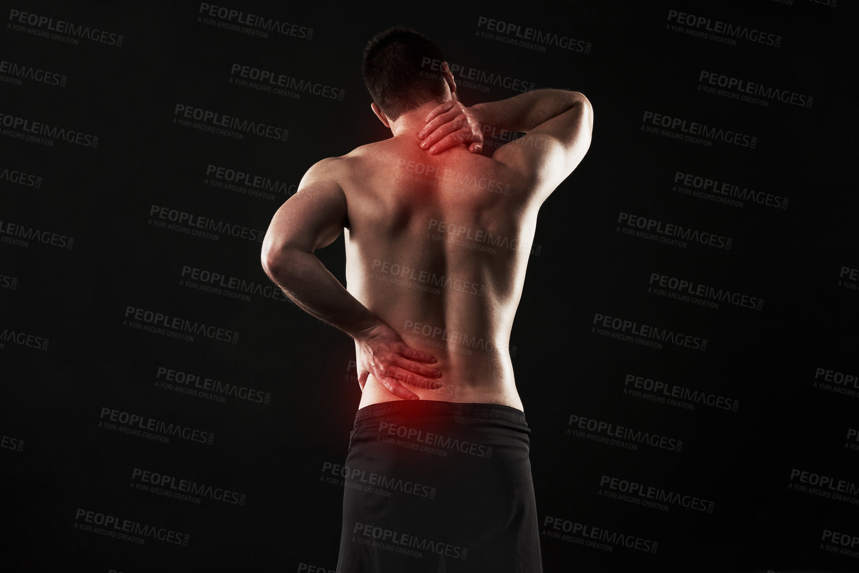 Buy stock photo Studio shot of a sporty young man suffering with  back and neck pain isolated on black