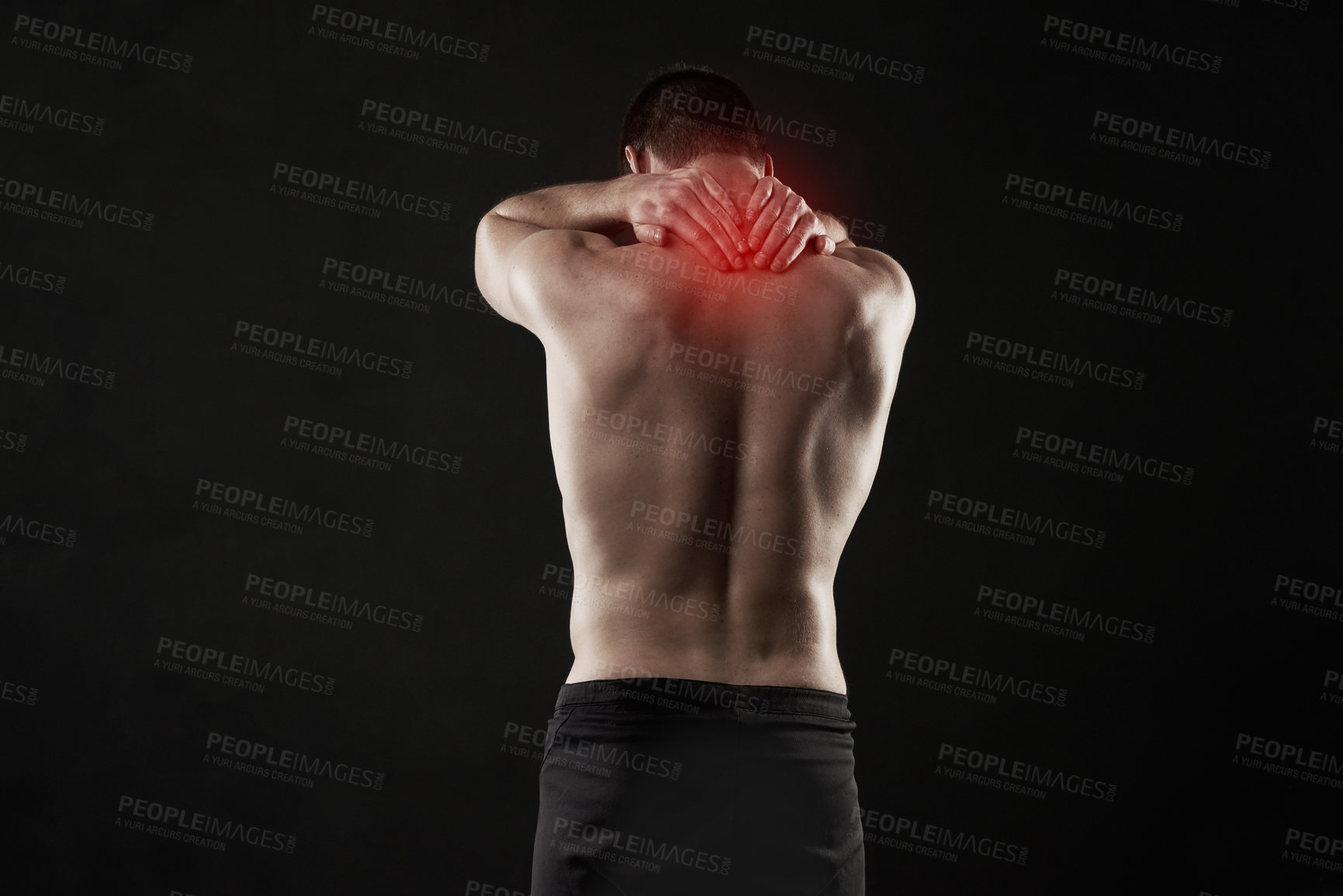 Buy stock photo Studio shot of a sporty young man suffering with neck pain isolated on black