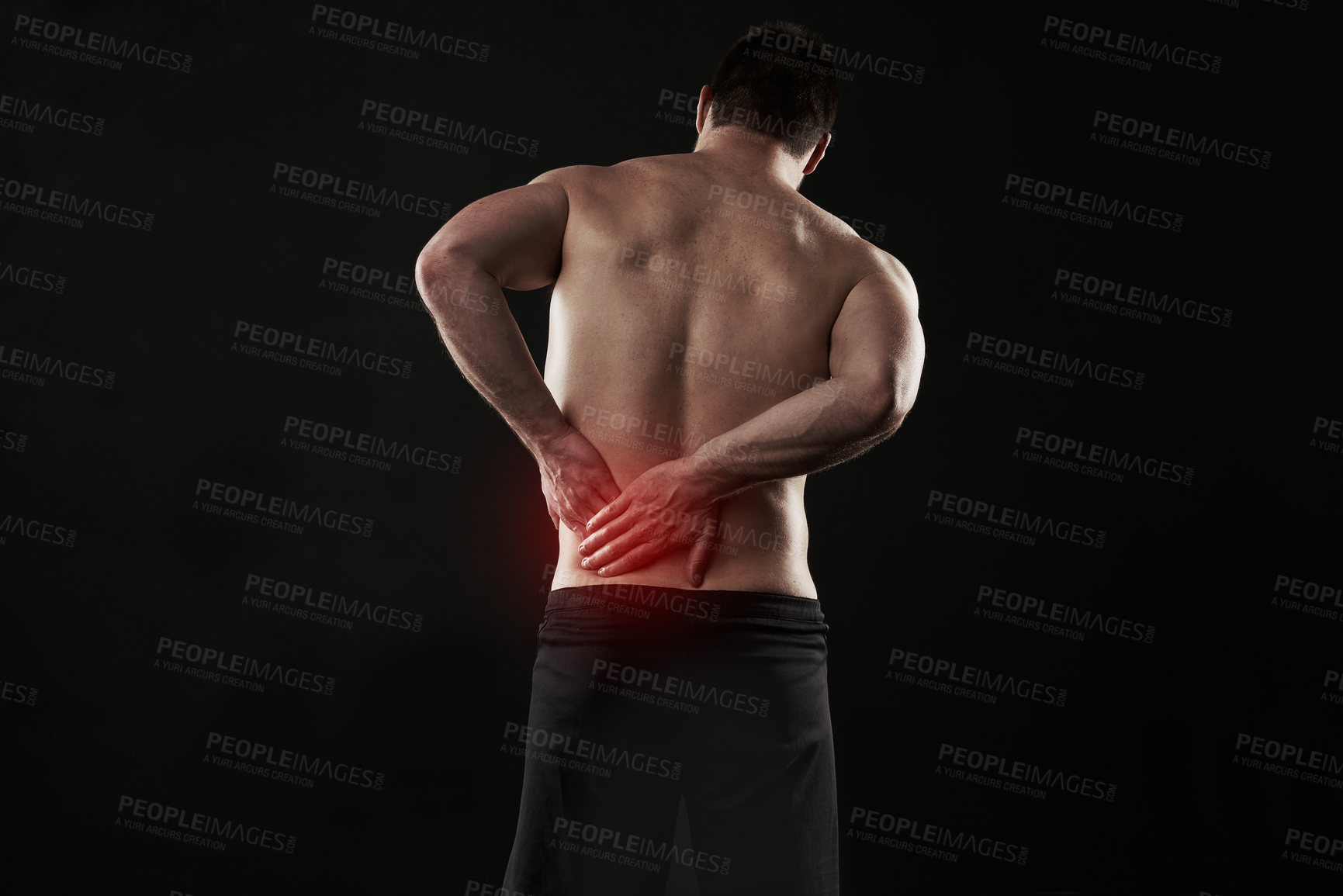 Buy stock photo Back pain, injury and red glow with man on black background for accident, anatomy or emergency. Fitness, healthcare and medical with shirtless athlete holding sore or stiff muscle in discomfort