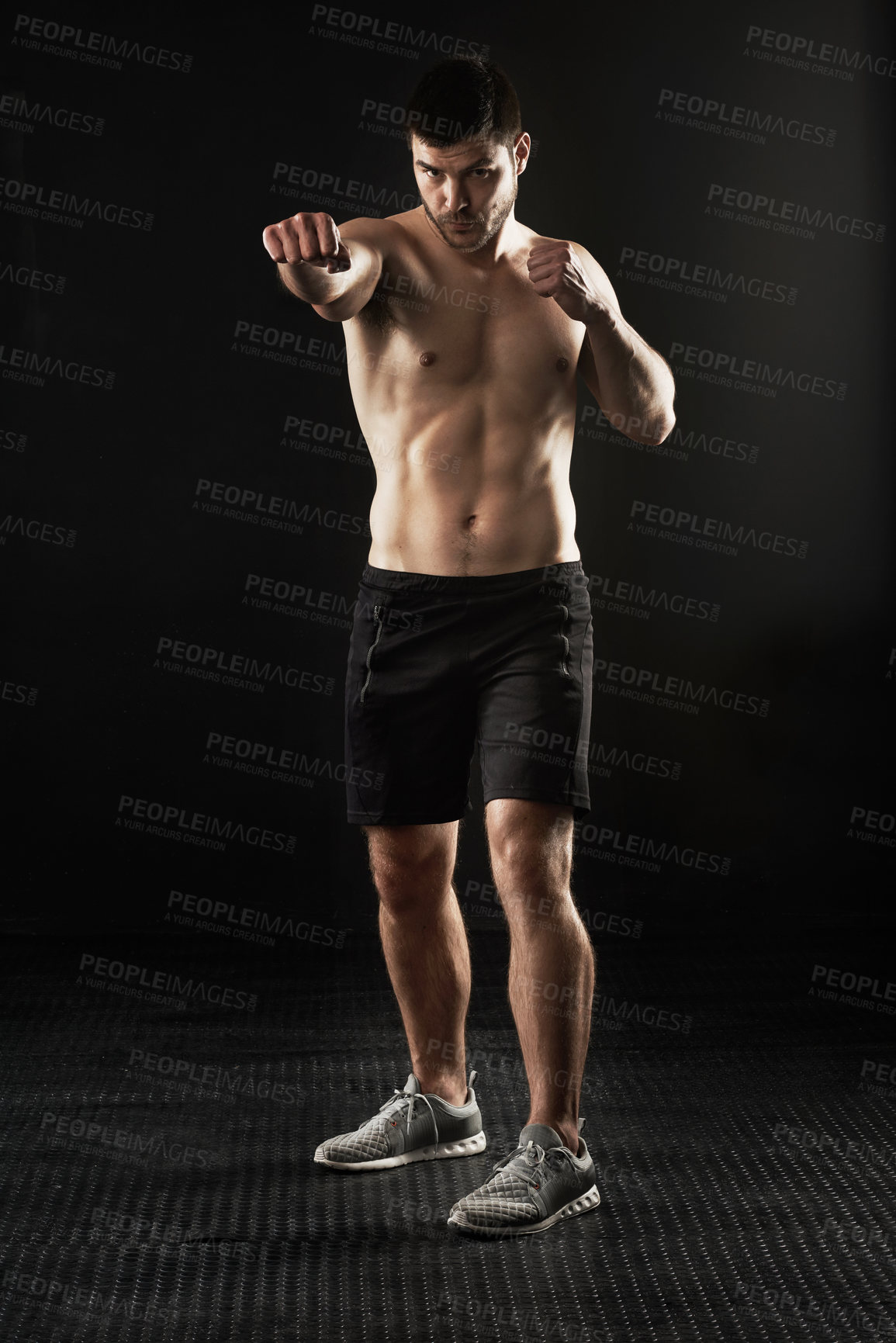 Buy stock photo Studio portrait of a sporty young man isolated on black