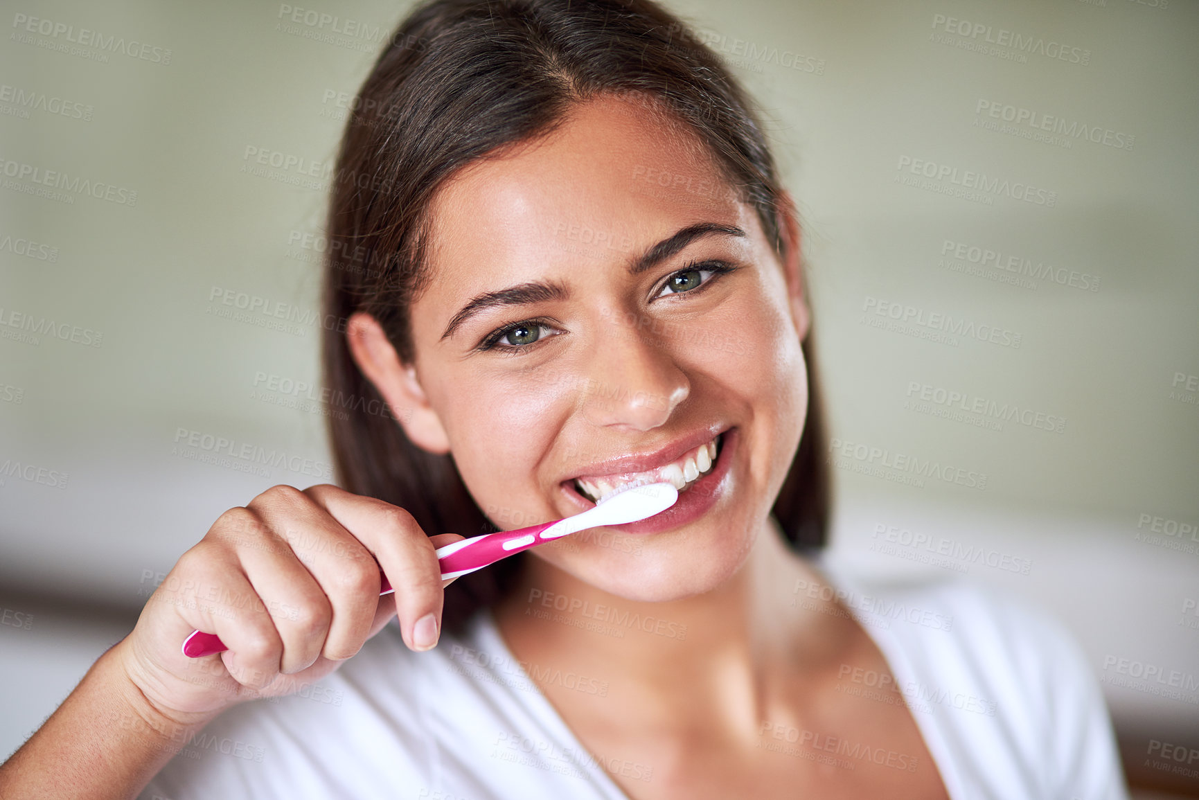 Buy stock photo Portrait of a beautiful woman brushing her teeth in the bathroom at home