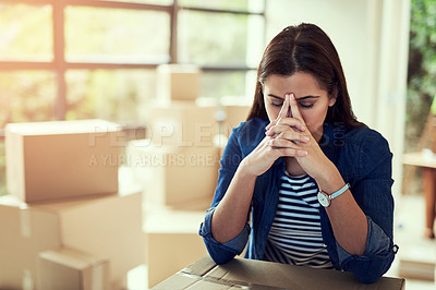 Buy stock photo Cropped shot of a young woman looking stressed out while moving house