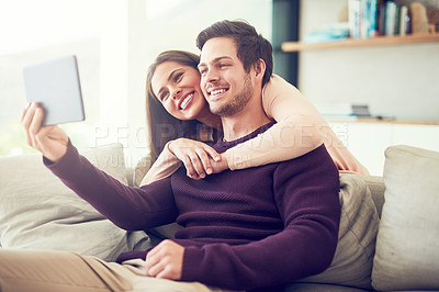 Buy stock photo Couple, selfie and hug on sofa in home living room with memory, profile picture or vlog on web. Man, woman and happy for photography, embrace and bonding on couch in lounge with post on social media