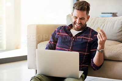 Buy stock photo Shot of a young man using a credit card to make an online payment at home