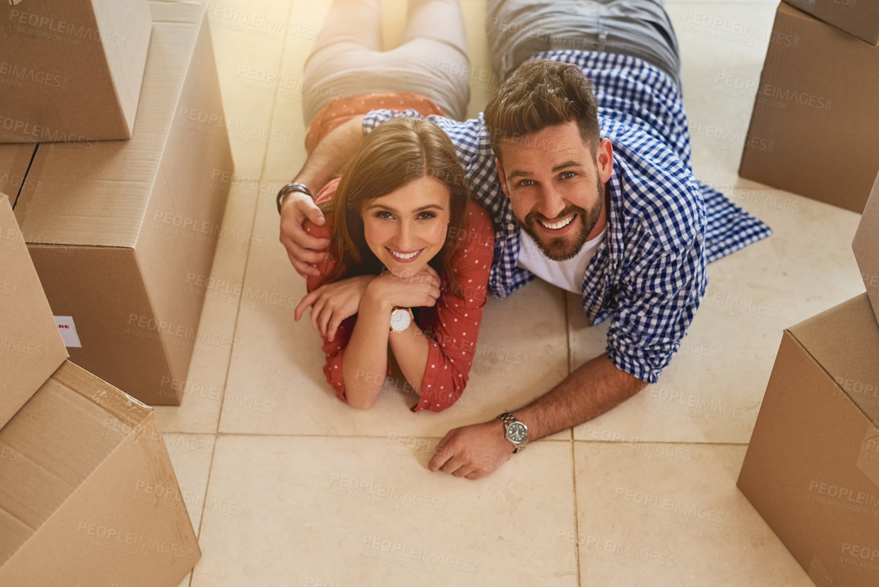Buy stock photo Portrait of a young couple taking a break while moving into their new home