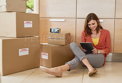 Buy stock photo Shot of a young woman taking a break while moving into her new home