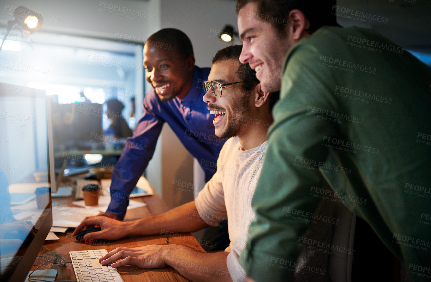 Buy stock photo Shot of a team of young businesspeople working late in the office