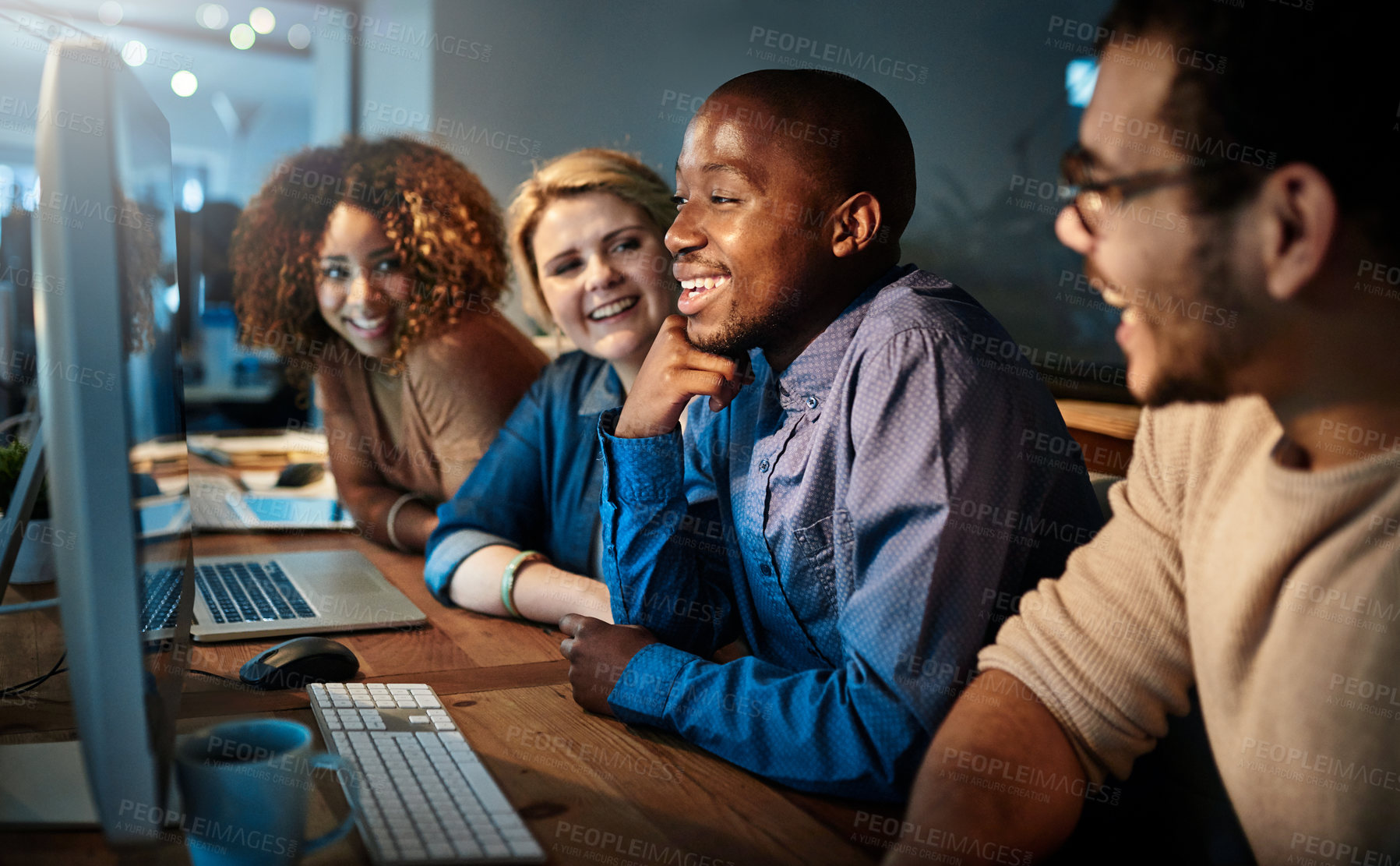 Buy stock photo Shot of a team of young businesspeople working late in the office